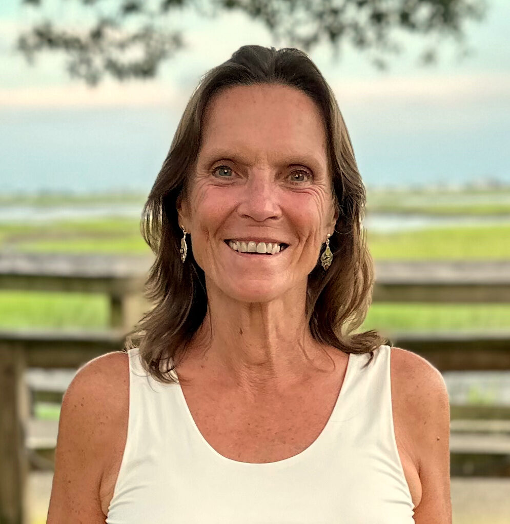 Paula Huffman smiling outdoors along the North Carolina coast